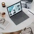 black laptop computer on round table on a Surface Laptop