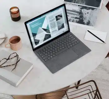 black laptop computer on round table on a Surface Laptop