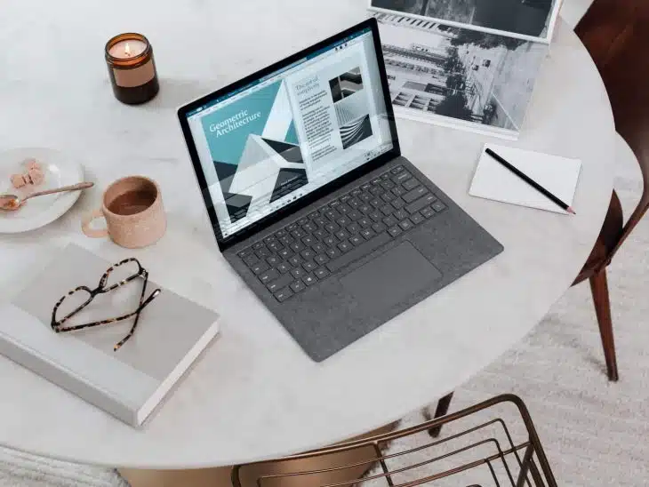 black laptop computer on round table on a Surface Laptop